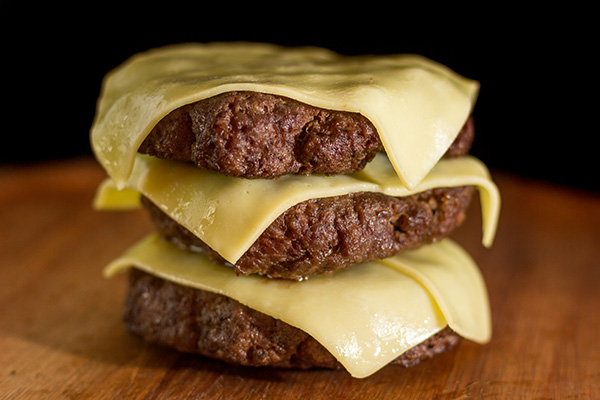 Hambúrguer Caseiro Com Queijo Sobre Uma Tábua de Madeira