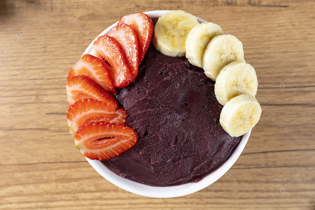 Tigela de Açaí com Bananas e Morangos Sobre uma Mesa de Madeira Visto de Cima