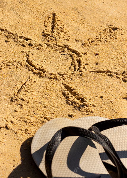 Sun Drawn On The Beach Sand With Flip Flops