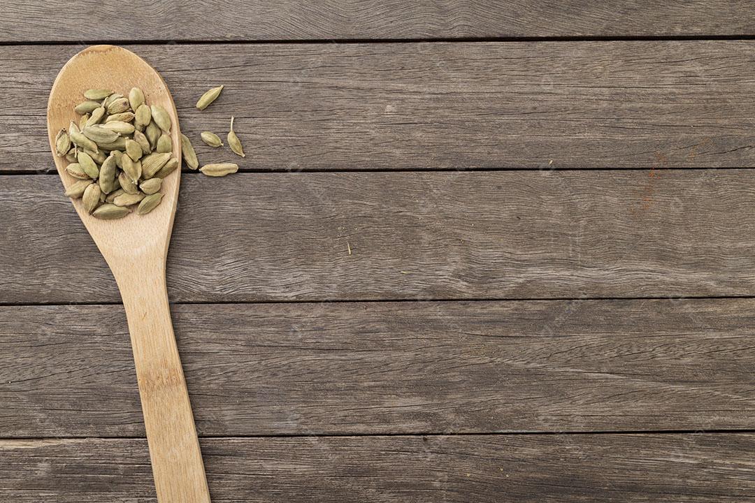 Sementes de Cardamomo Em Uma Colher Sobre Mesa de Madeira Imagem JPG