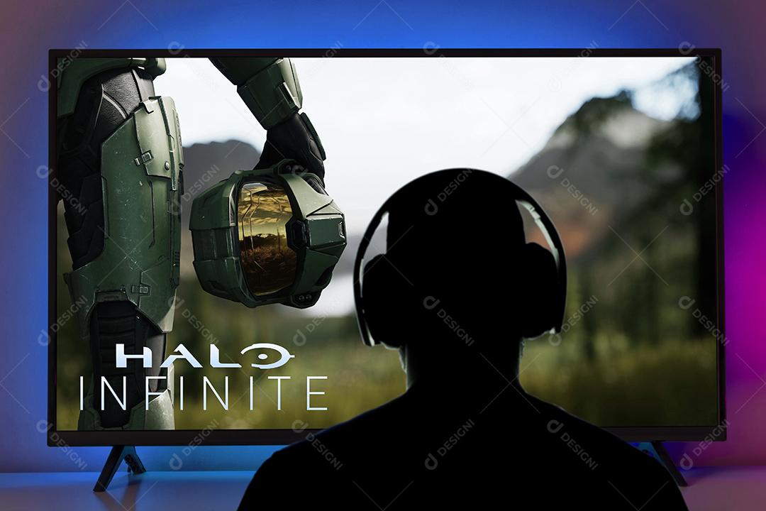 Homem Tocando Novo Halo Infinite na Tv Com Fones de Ouvido Imagem JPG