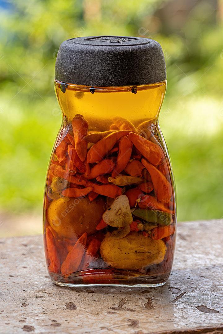 Pote de Conserva de Pimenta em Óleo com Pequi Imagem JPG