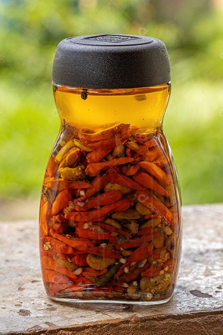 Pote de Conserva de Pimenta em Óleo com Pequi Imagem JPG