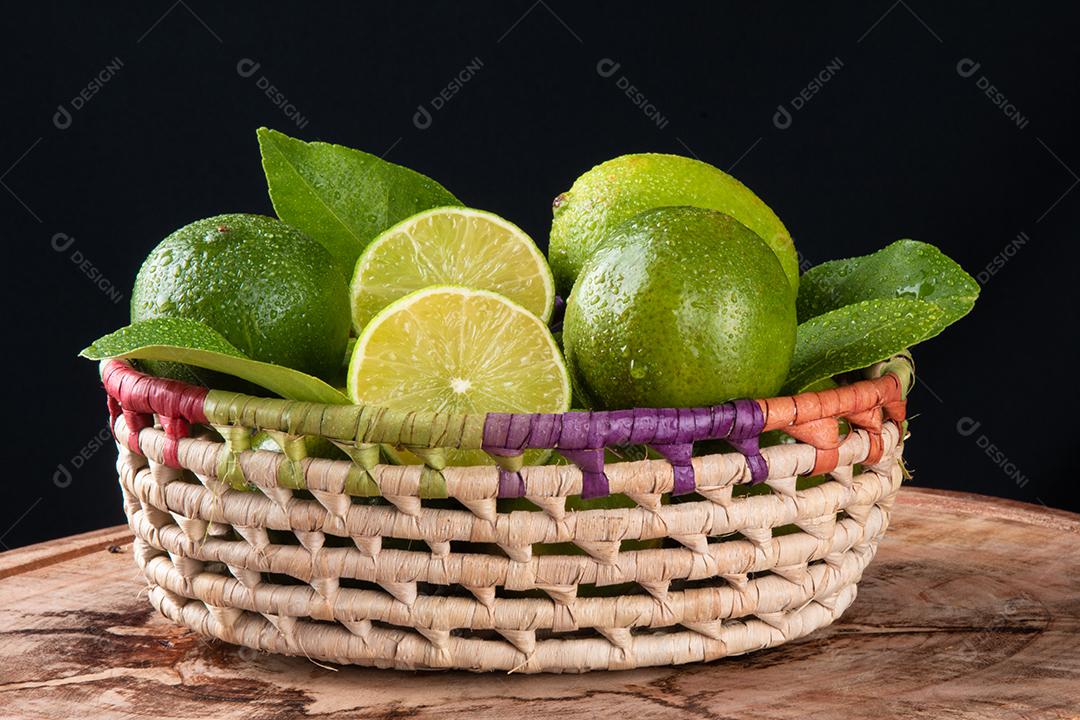Green Lemon Fruits in Basket With Black Background Image JPG