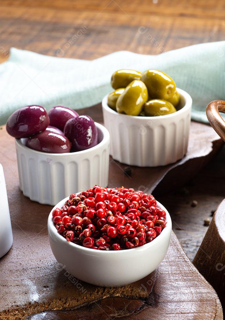 Red Pepper Served In A Bowl And Blurred Olives In The Background Image JPG