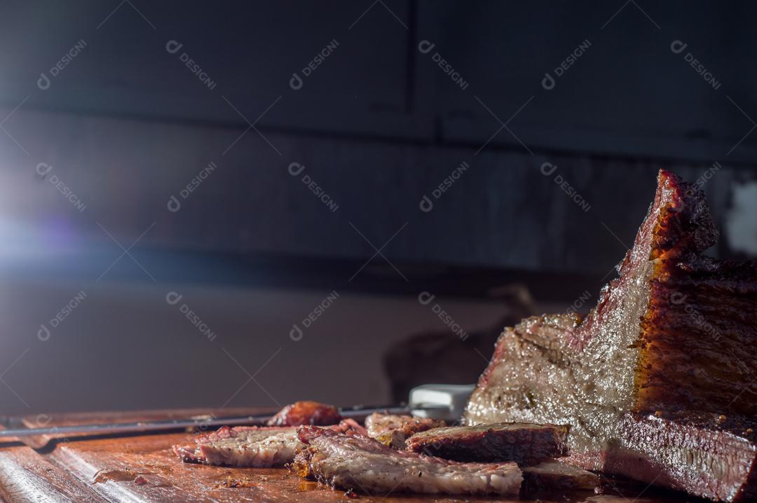 Fotos Homem cortando e manipulando um pedaço de peito defumado, com luz natural