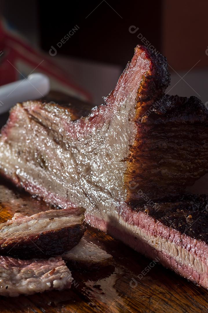 Fotos Homem cortando e manipulando um pedaço de peito defumado, com luz natural