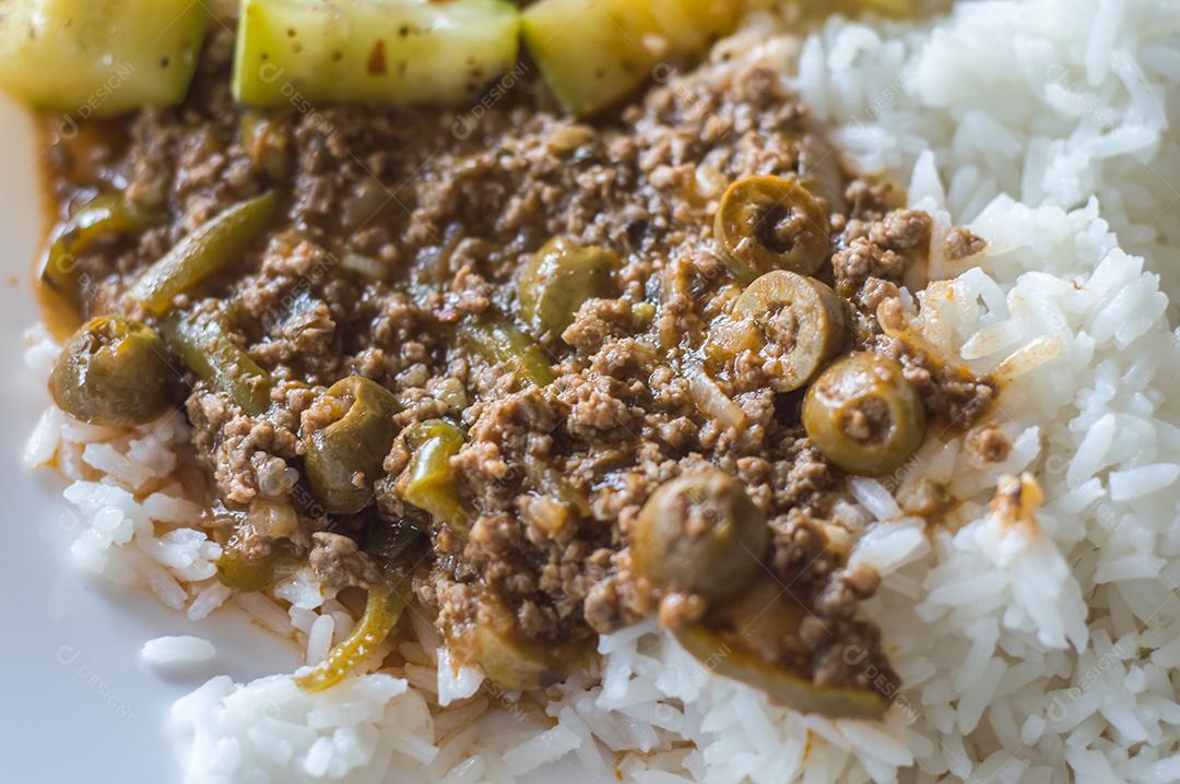 Comida caseira, prato de arroz, carne moída com azeitonas e abóbora cozida