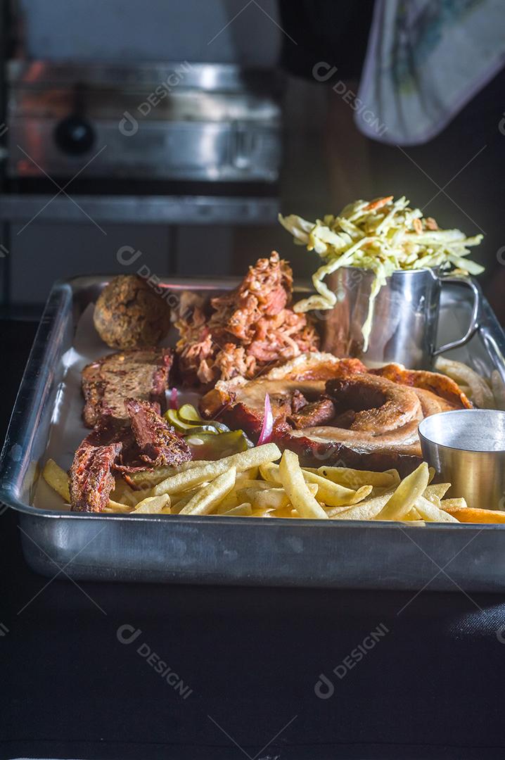 American barbecue platter with porchetta, pulled pork