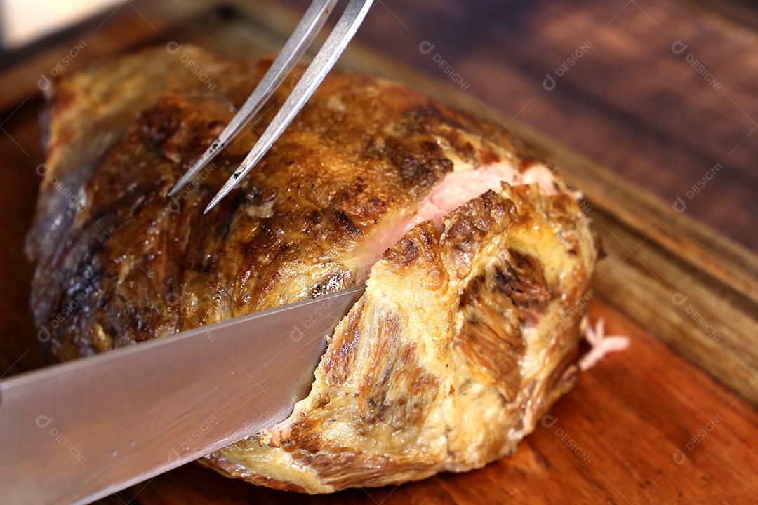 Termite or Termite. Traditional Brazilian Nellore beef cord cut under a wooden board with a barbecue knife JPG