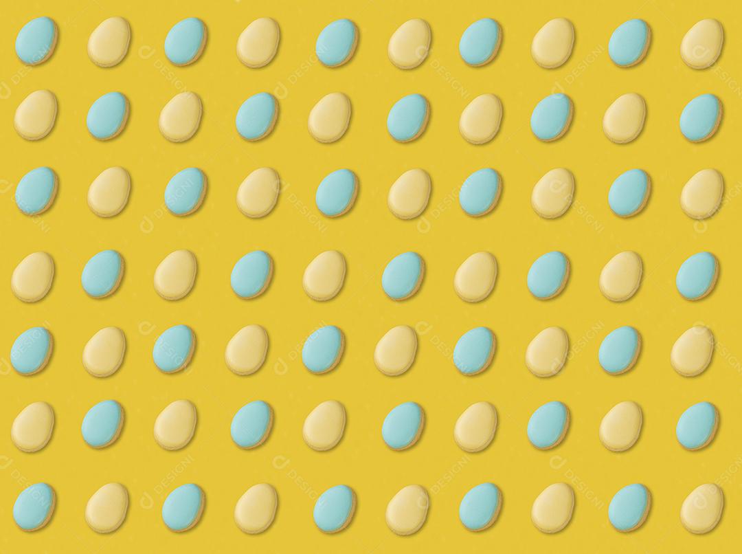 Biscoitos de ovos de páscoa azuis e amarelos sobre fundo amarelo JPG