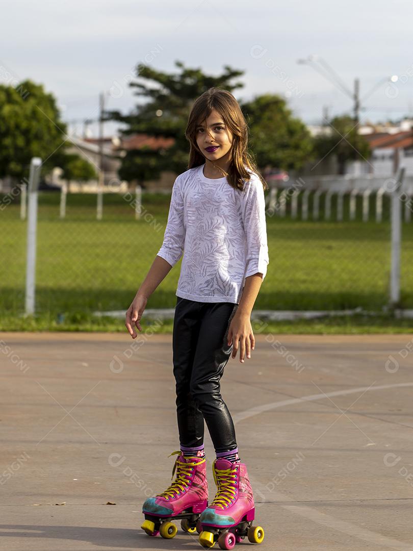 Garota andando de patins em uma quadra Imagem JPG