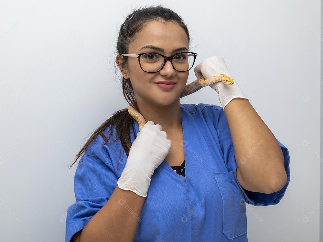 Veterinarian examining an albino molurus python snake Image JPG