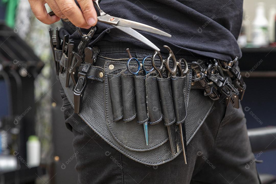 Leather barber belt with all the scissors on the waist Image JPG