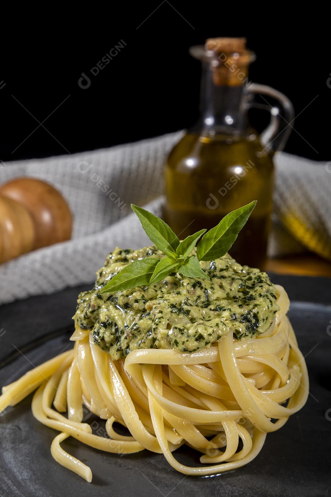 Spaghetti pasta with pesto sauce and fresh basil leaves Image JPG