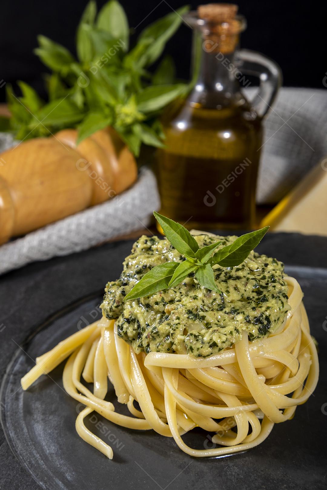 Pasta spaghetti with pesto sauce and fresh basil leaves Image JPG