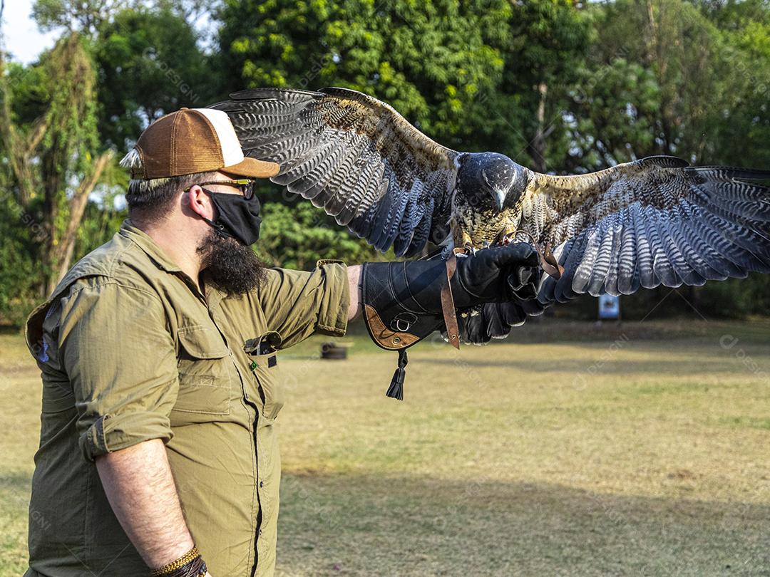 Homem segurando uma aguia passaro aves
