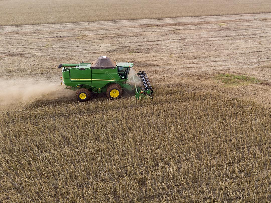 Trator agrícola colhendo soja no campo Imagem JPG