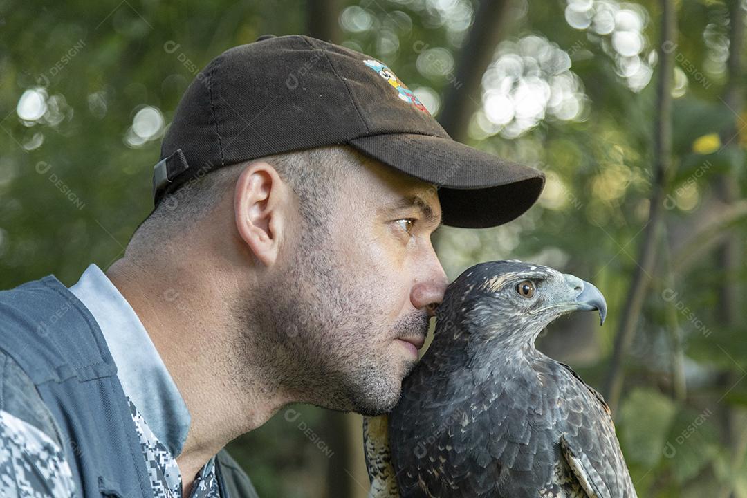 Homem segurando falcao aves passaros