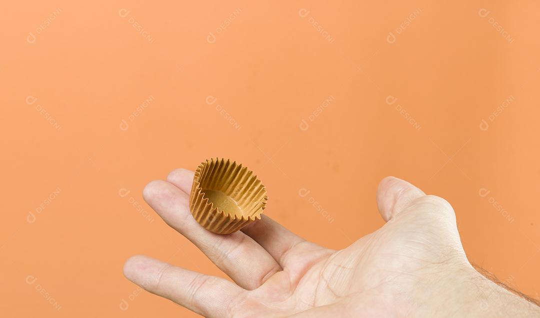 Woman's hand holding a vegan brigadeiro. Typical Brazilian swe