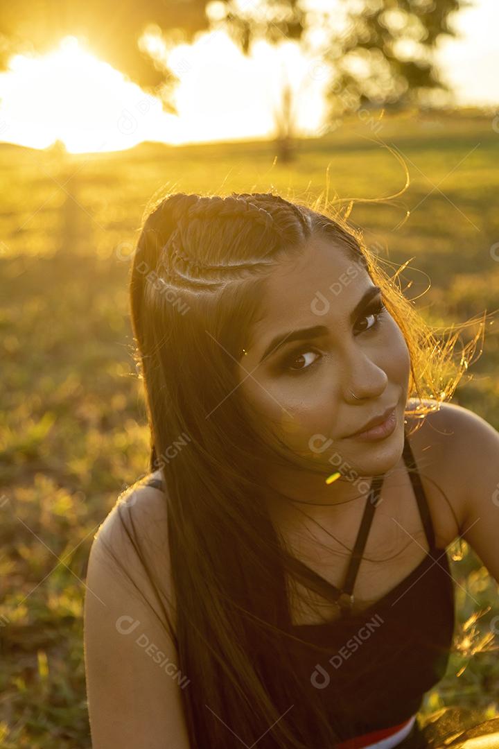 Beautiful brunette girl posing in nature photos at sunset