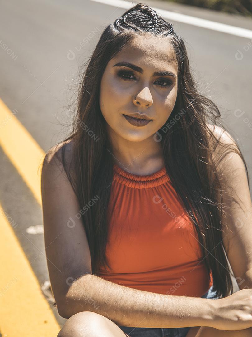 Linda menina morena posando em fotos na natureza por do sol