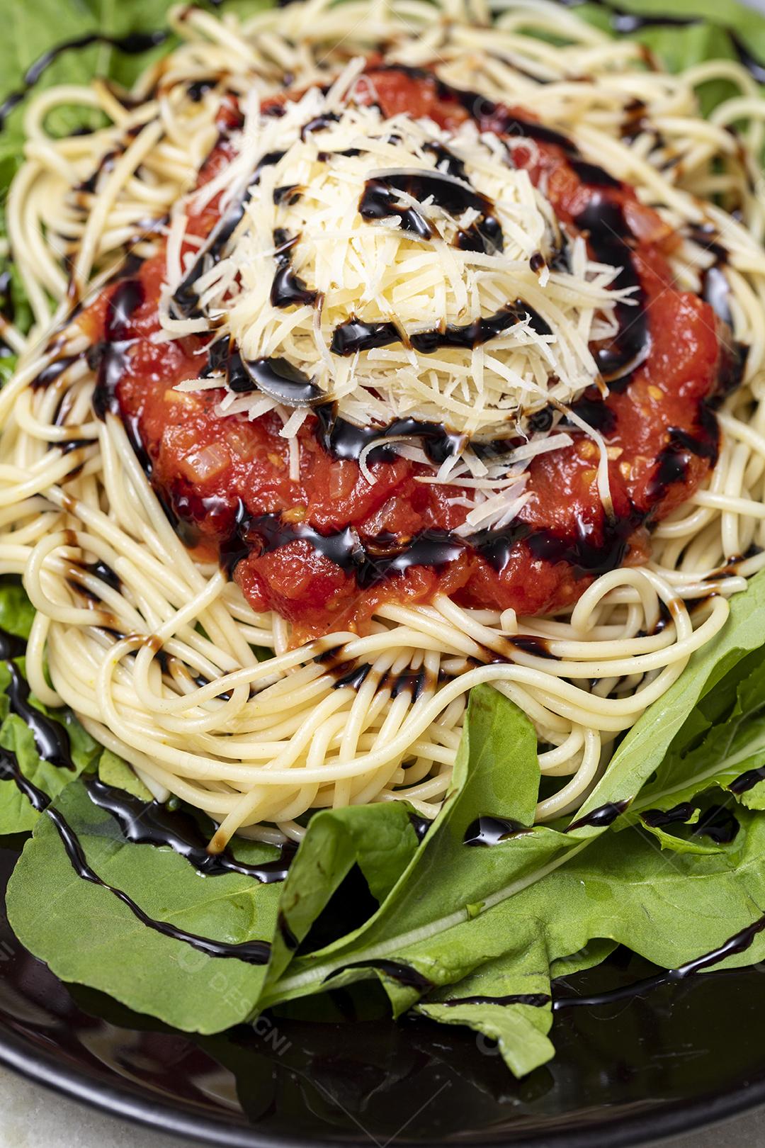 Macarrão espaguete com molho vermelho e rúcula Imagem JPG
