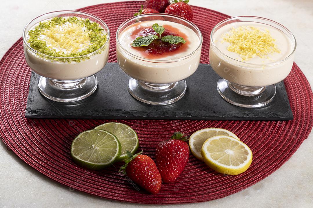 Delicious lemon and strawberry mousses in glass jars on top Image JPG