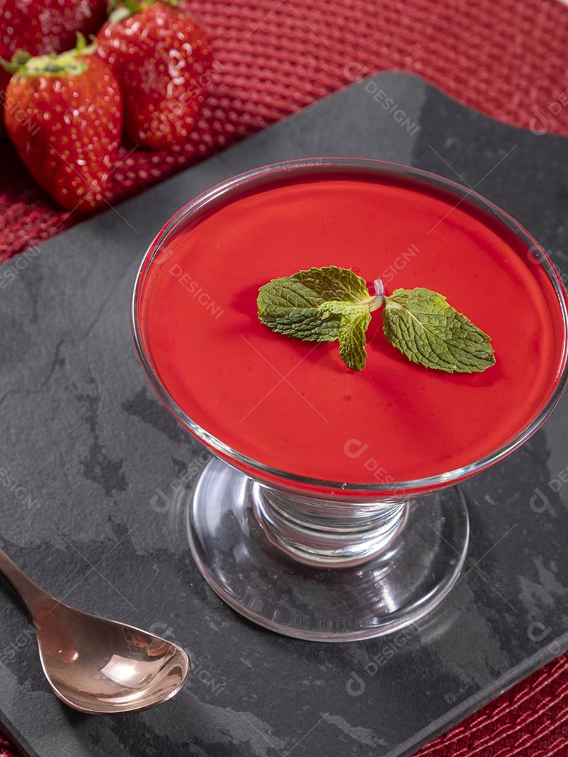 Tasty strawberry mousse in glass with gelatin on top