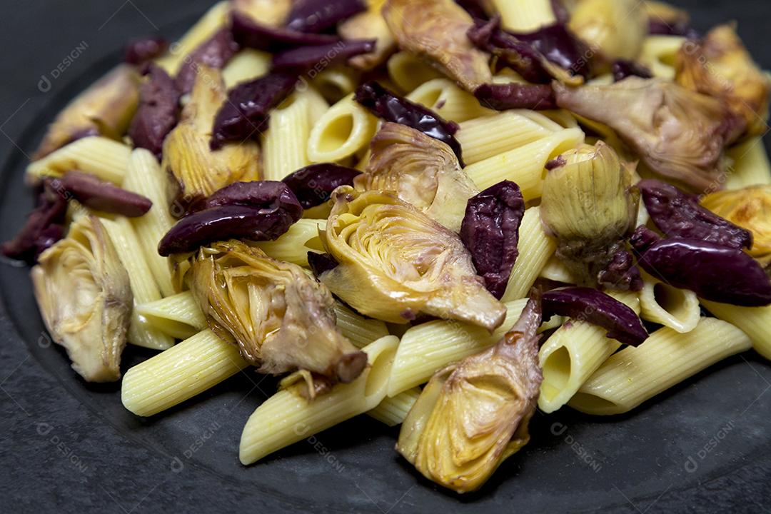 Massa com azeitonas pretas e corações de alcachofra, coberto com fresco