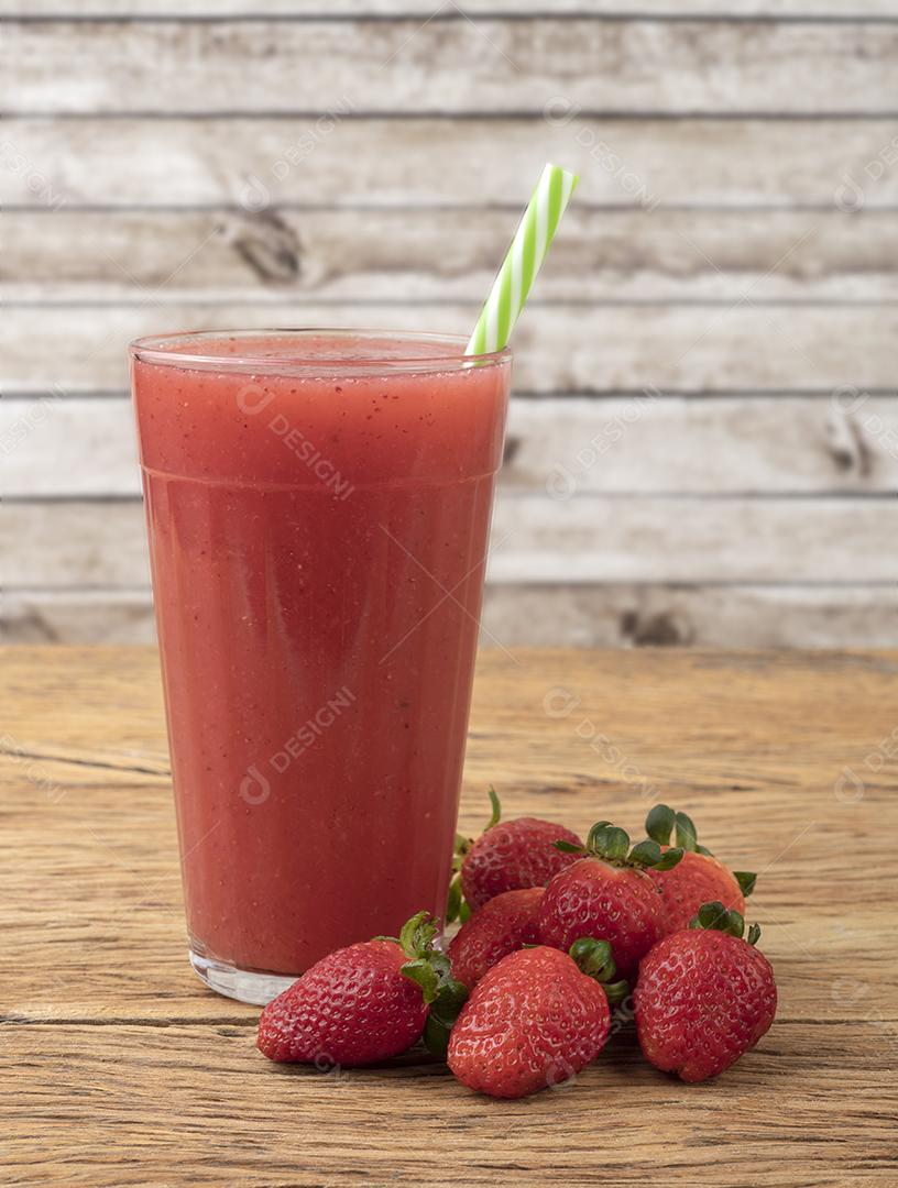 Strawberry Juice in a Glass with Berries on Wooden Table JPG