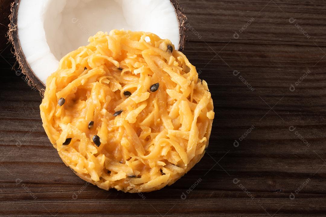 Doce de coco cocada em fundo de madeira rústica