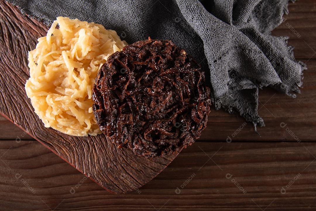 Doce de coco cocada em fundo de madeira rústica