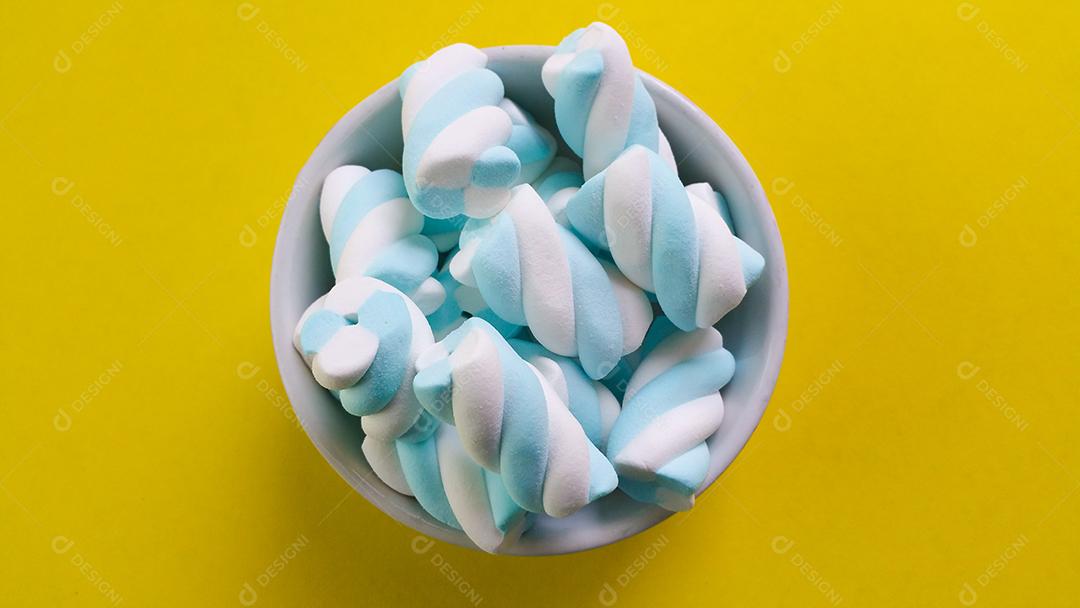 Doces de Marshmallow azul e branco em tigela branca e amarelo