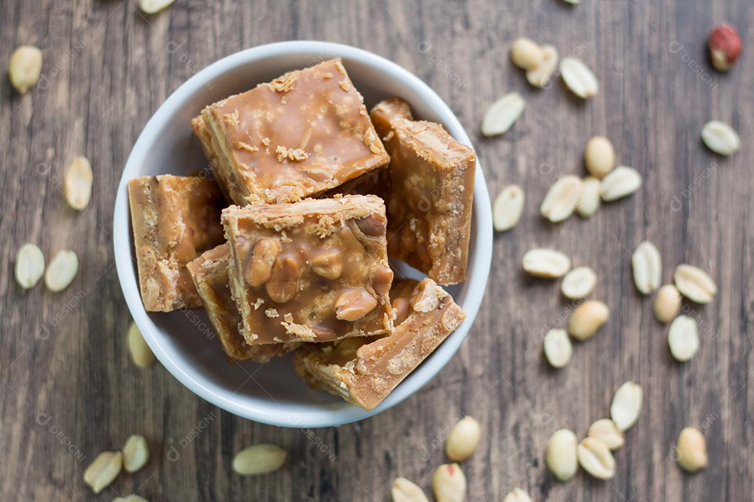 pedaços de doce de leite com amendoins em tigela branca