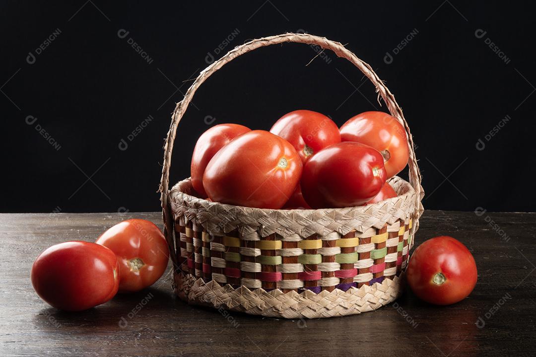 Tomate vermelho na cesta com fundo preto