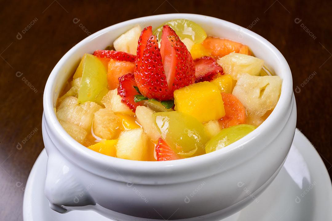g007 Fruit salad with strawberry, green grape, mango and pineapple. Served in a white bowl