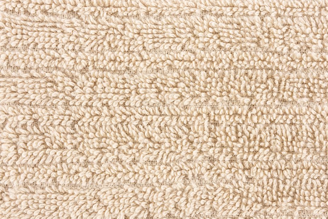 Close up de uma toalha marrom clara. Pano de fundo de detalhes têxteis.