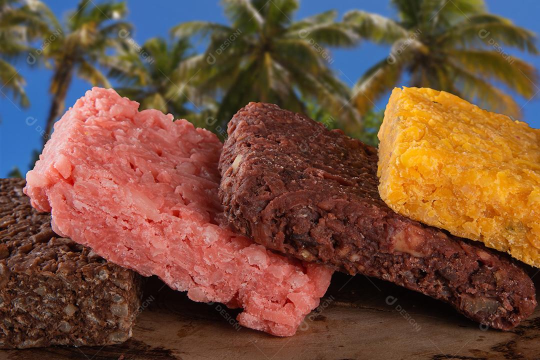 Coconut candy cocada, brazilian sweet on rustic wooden background