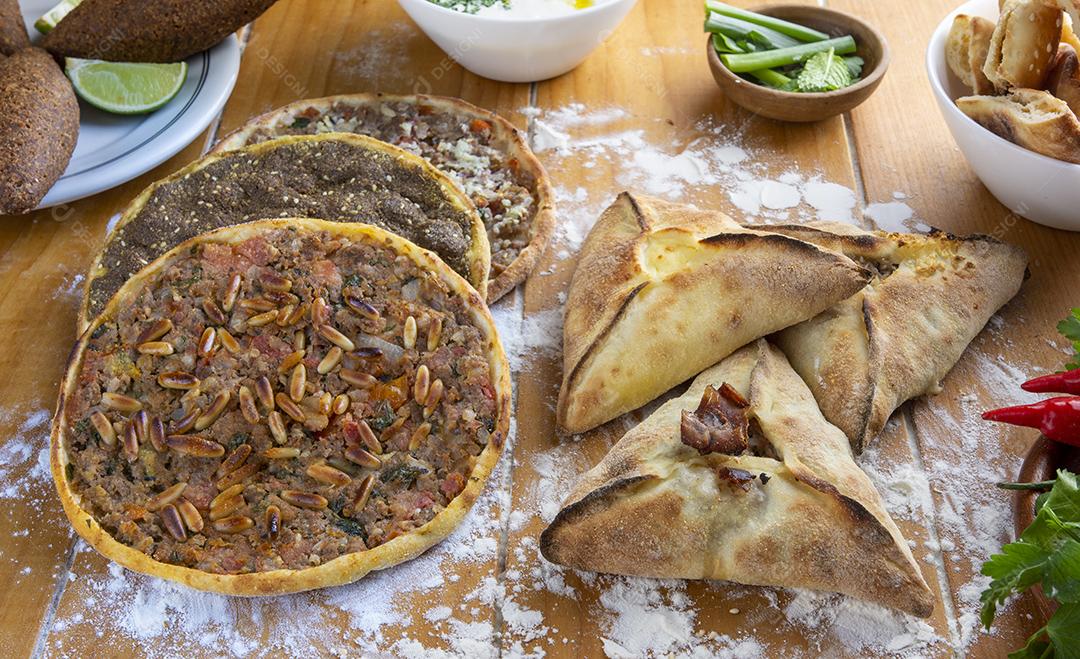 Comida árabe tradicional com ingredientes sobre farinha em uma madeira