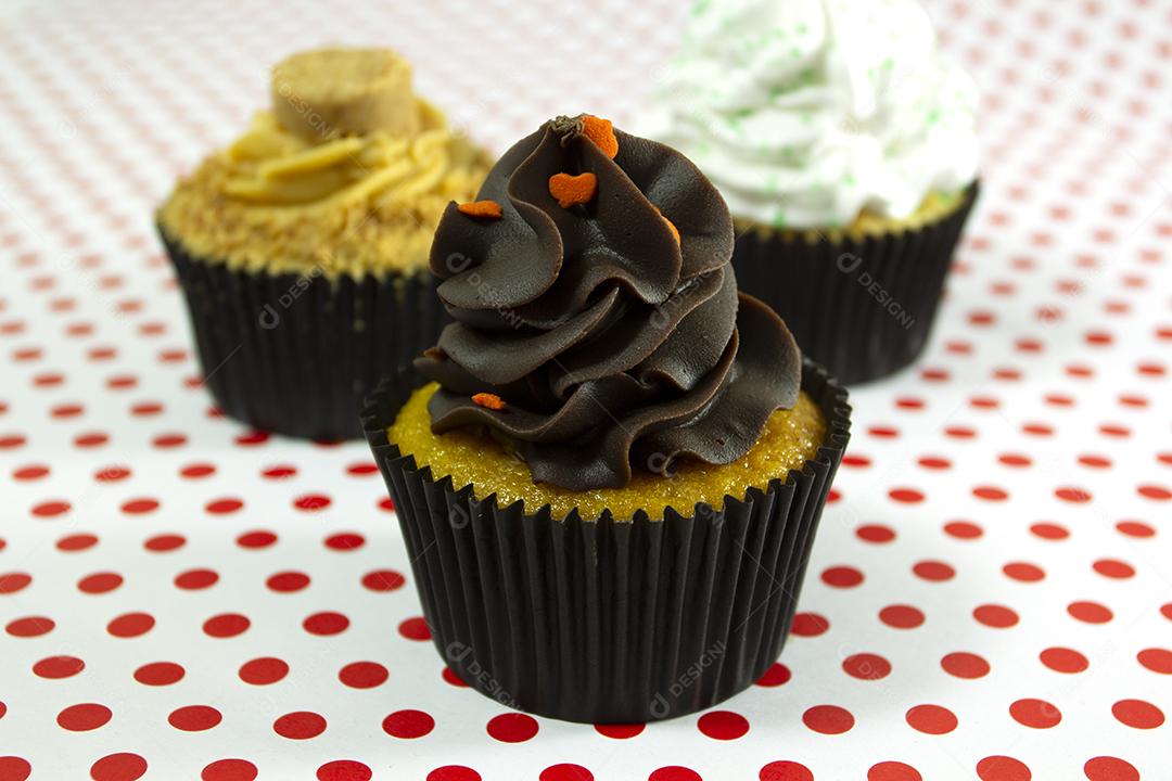 Cupcakes on red dots background.