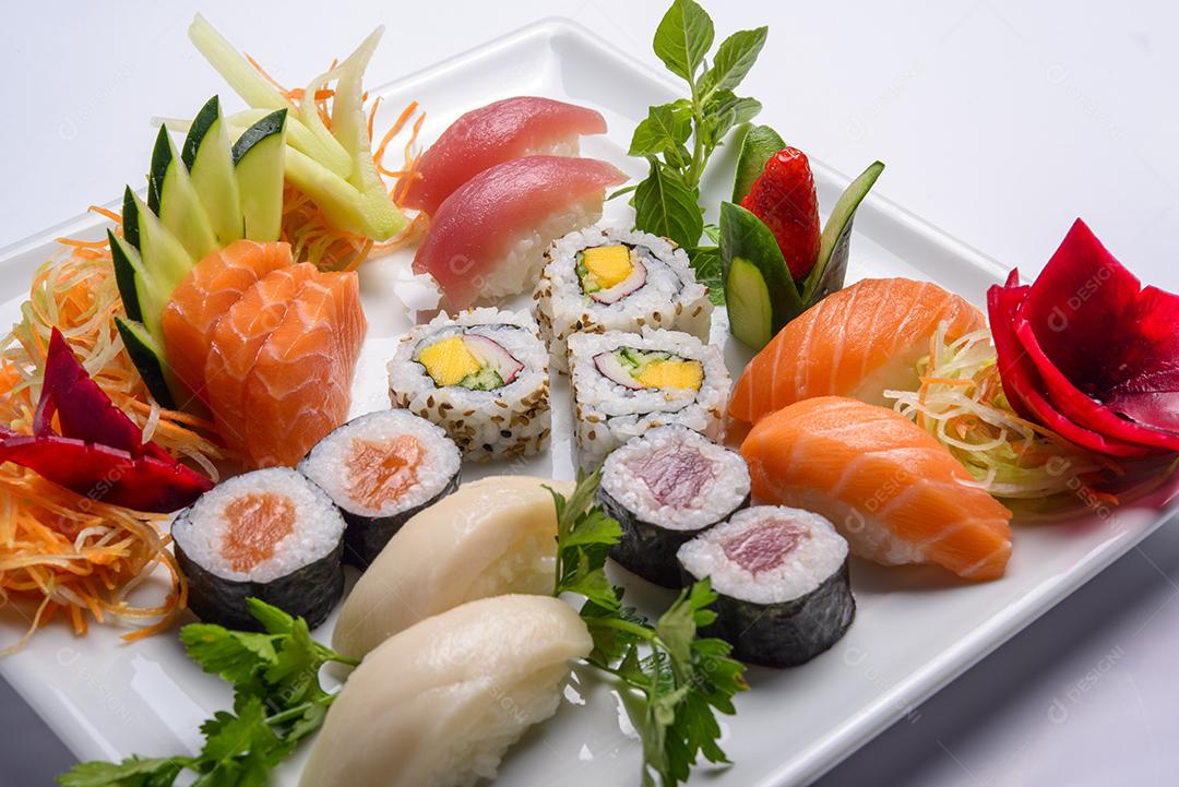 Mistura de comida japonesa, incluindo sushi e sashimi no prato branco