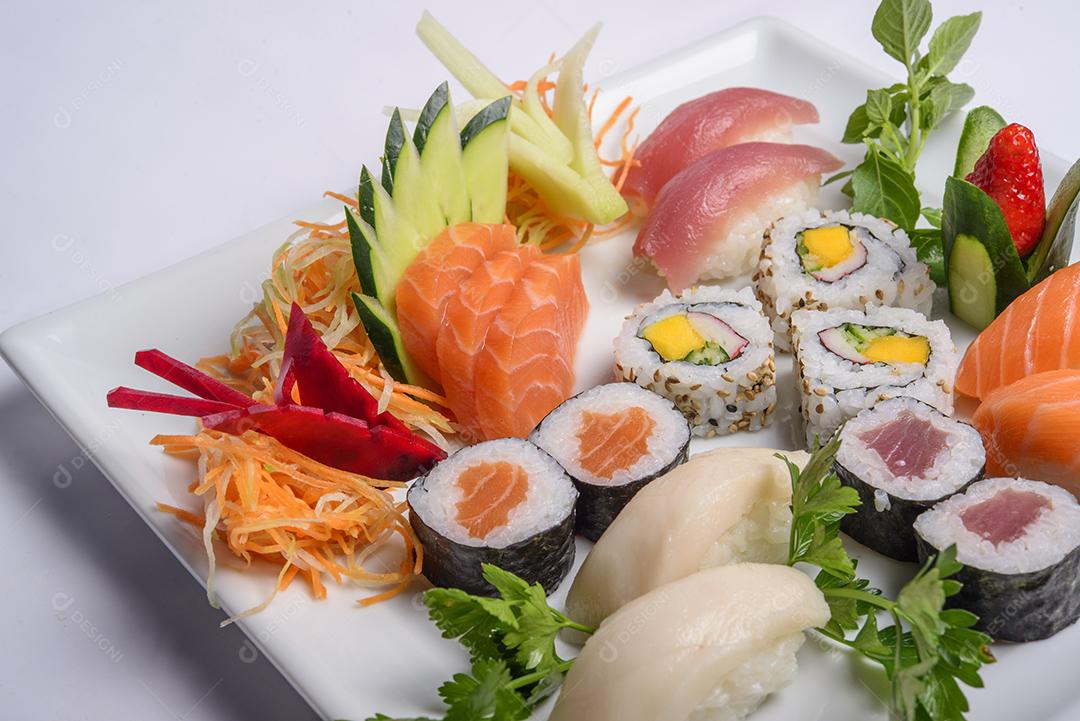 Mistura de comida japonesa, incluindo sushi e sashimi no prato branco
