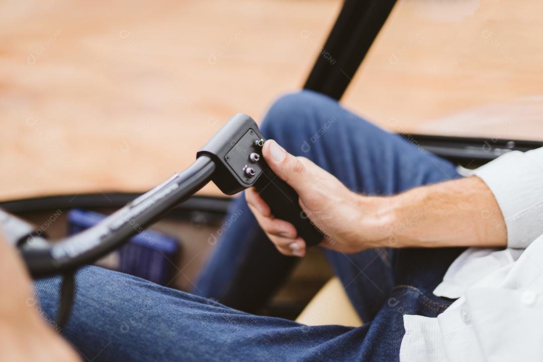 Aviador sentado no cockpit voando de helicóptero privado