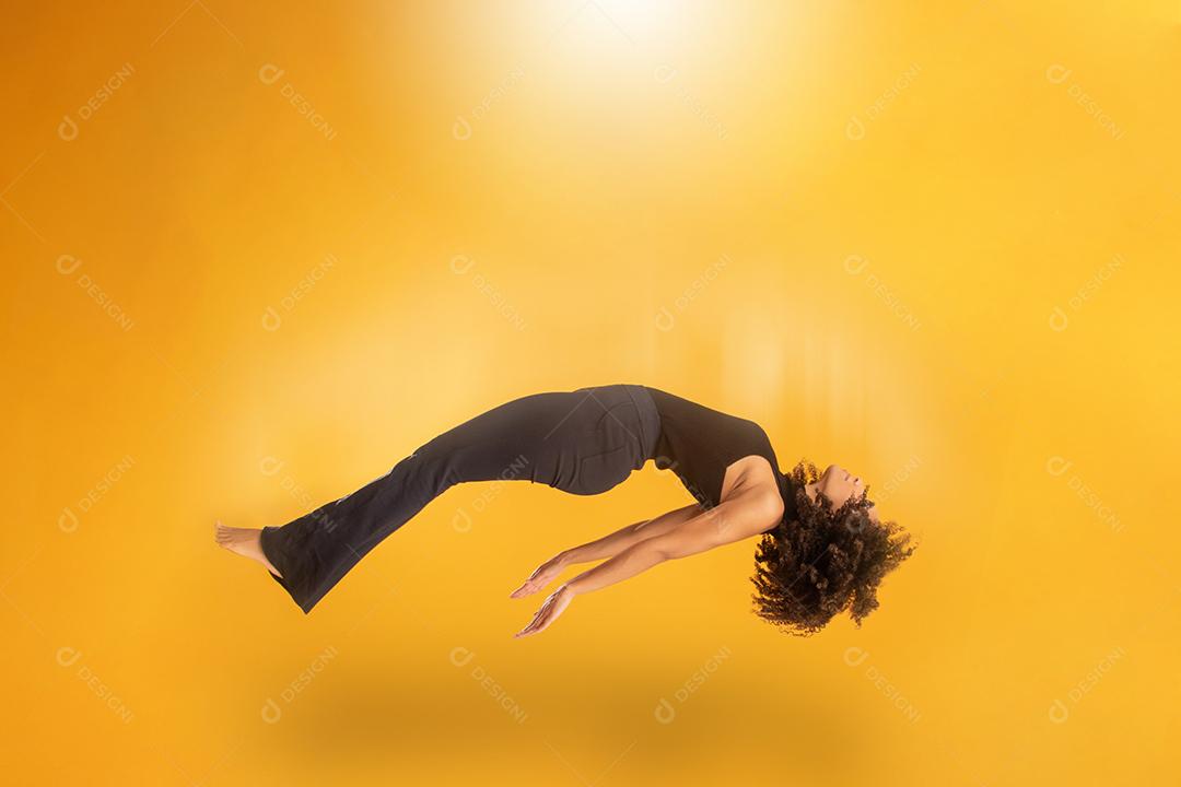 Vista lateral da mulher de cabelo afro em gravidade zero ou uma queda. Menina