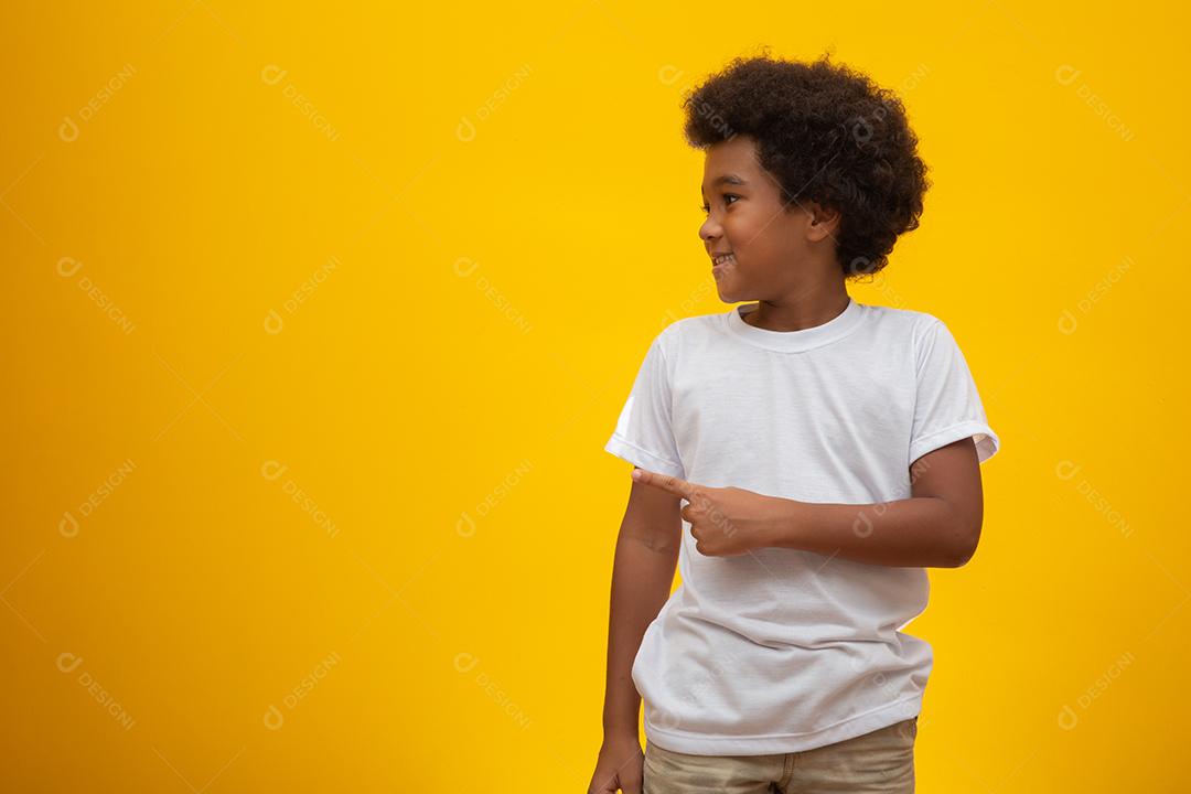 African American boy with black power hair on yellow background.