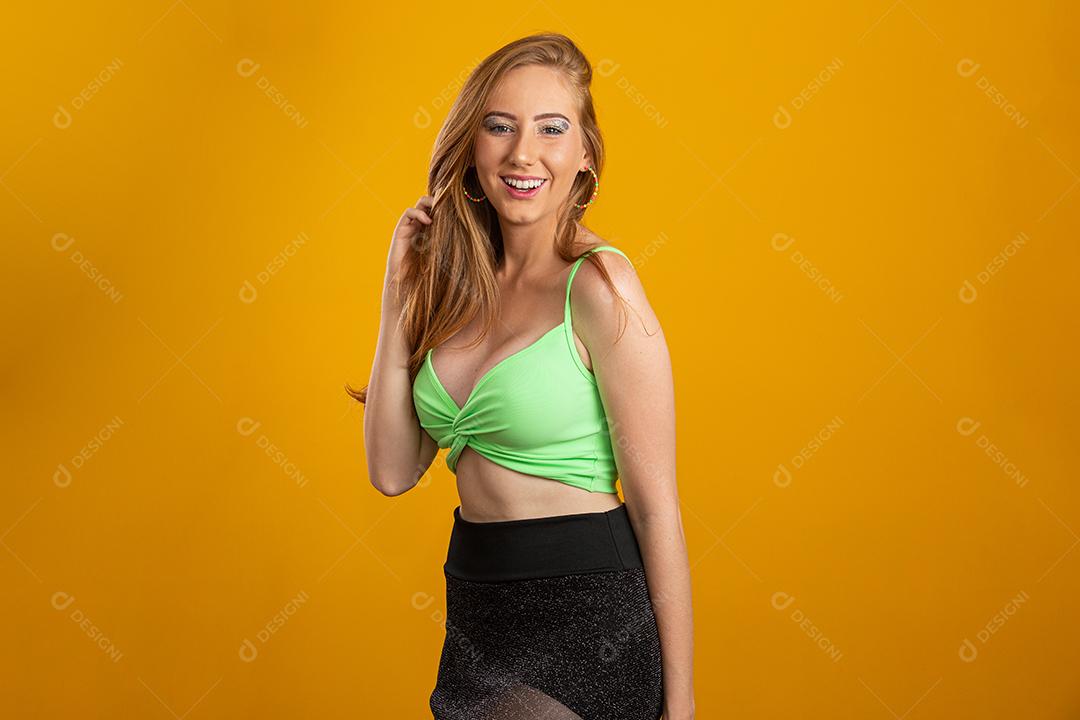 Portrait of beautiful cheerful redhead blonde smiling laughing looking at camera over yellow background.