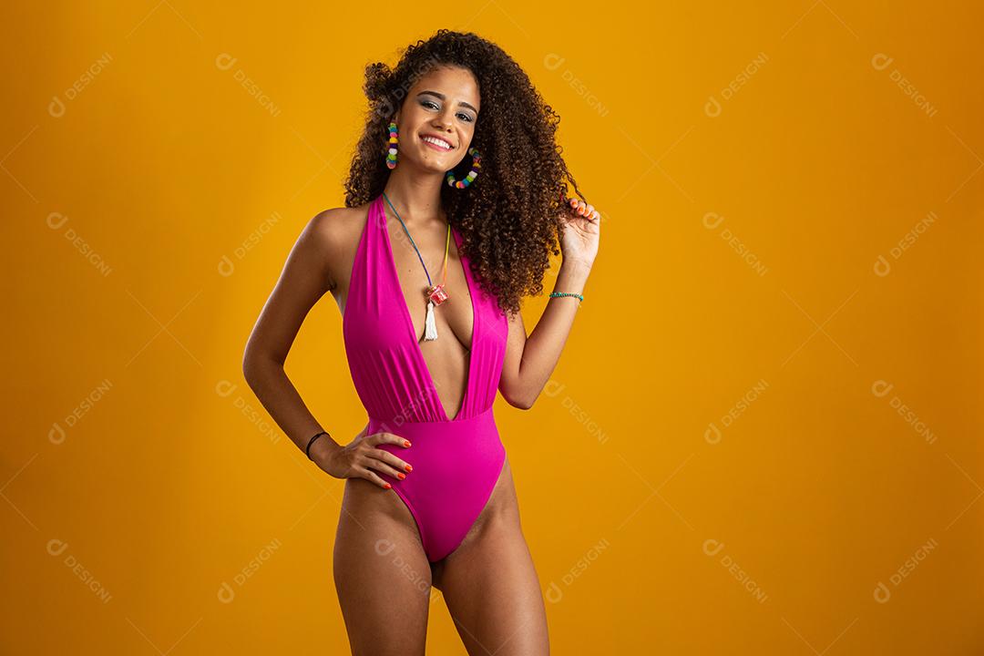 Beautiful African American girl with an afro hairstyle smiling. Woman beauty portrait