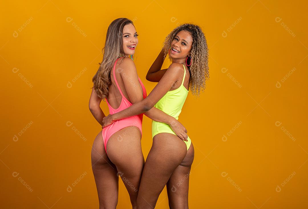 Carnaval brasileiro. Duas jovens fantasiadas curtindo a festa de carnaval. Amigos.