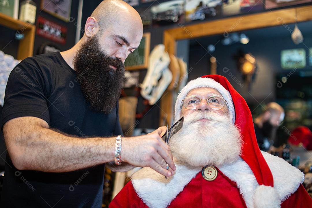 Papai Noel se barbeando na barbearia. Olhando no espelho